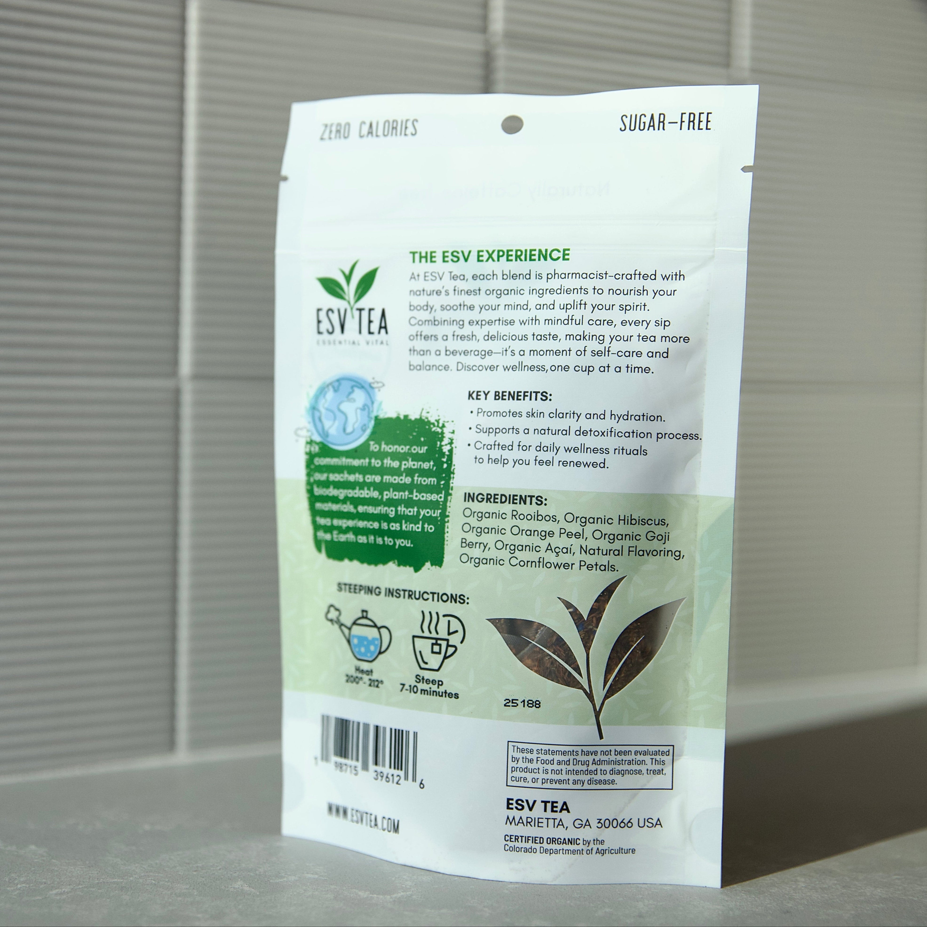 Tea package with green leaf design on a gray surface