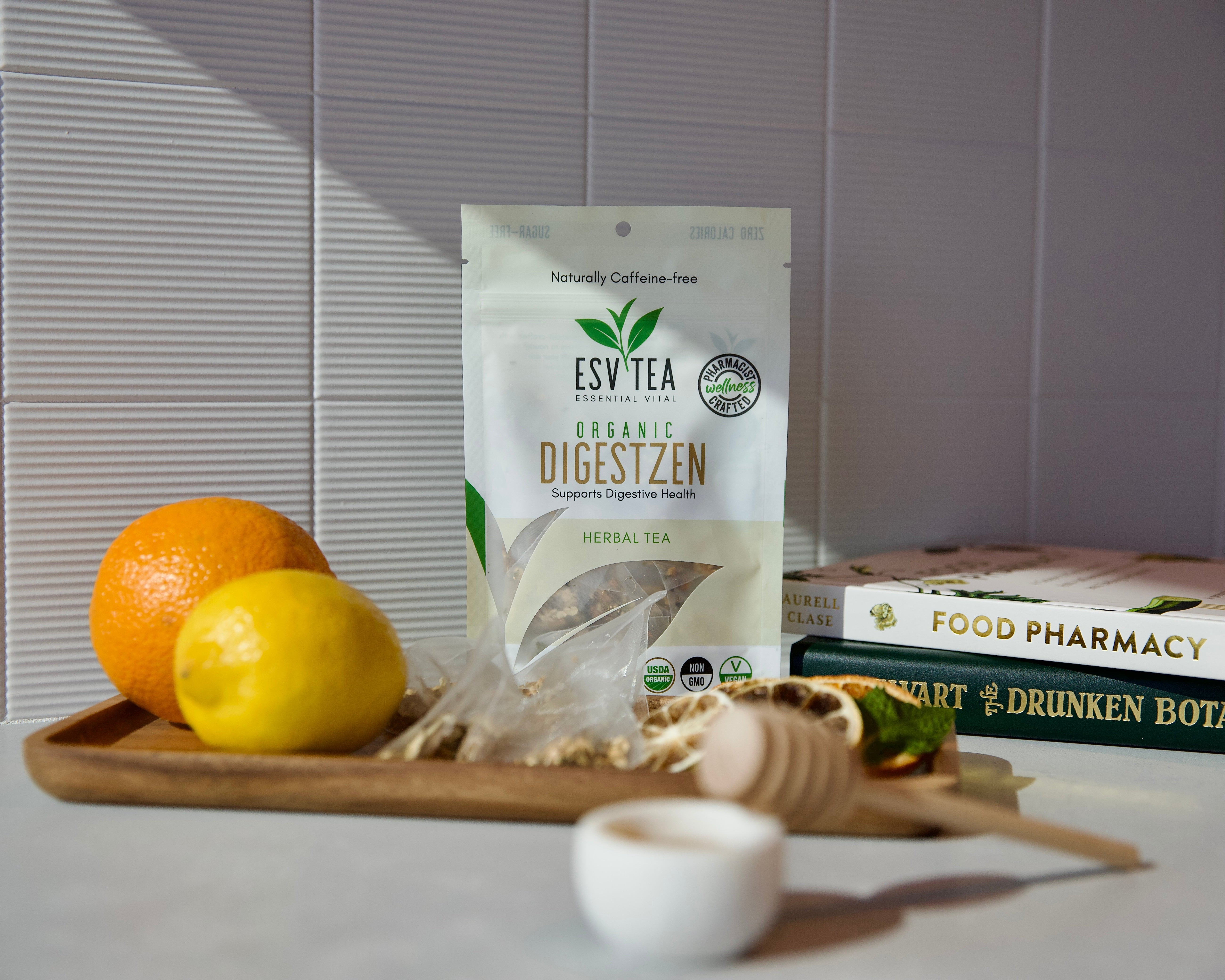 Esv Tea package on a wooden tray with fruits and books in the background